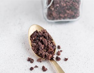 Cacao nibs on a spoon. Have prebiotic qualities