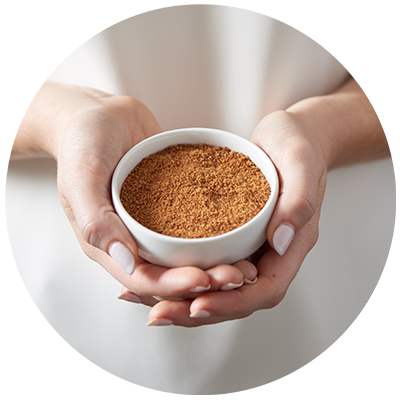 Coconut Sugar ingredient being cradled in bowl in hands, nothing artificial ever