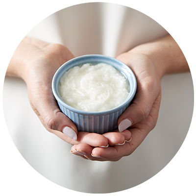 Coconut Oil ingredient being cradled in bowl in hands, nothing artificial ever