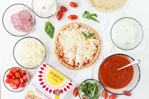 Pizza and pizza toppings made with Simple Mills Pizza Dough mix