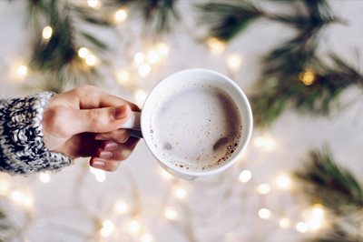 Person holding a cup of a hot beverage 