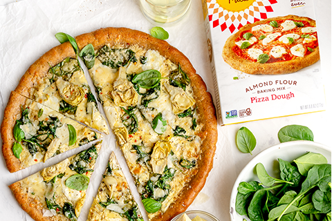 Spinach and Artichoke Pizza with ingredients and Pizza Dough Mix box