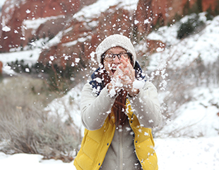 Holiday guest enjoying playing with snow