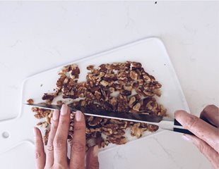 Walnuts being chopped on a cutting board. Nutrient dense food. 