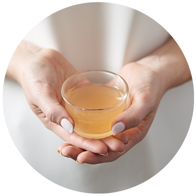 Apple Cider Vinegar ingredient being cradled in a bowl in hands, nothing artificial ever